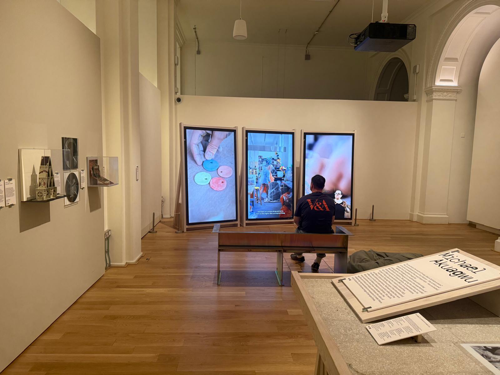 An exhibition gallery with art displays and video installations
